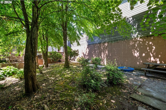 view of yard featuring a wooden deck and a patio area