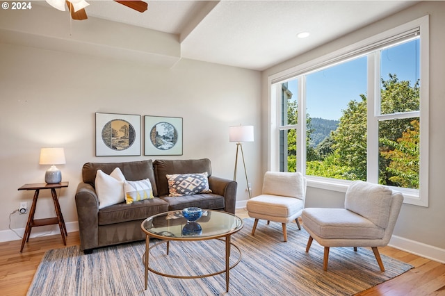 living room with ceiling fan, a healthy amount of sunlight, and light hardwood / wood-style flooring