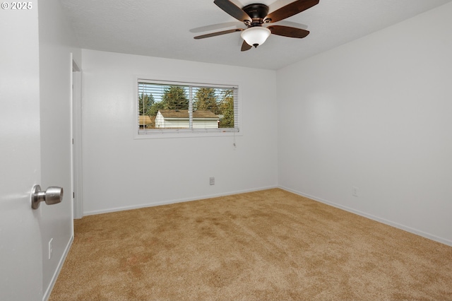 unfurnished room featuring light carpet and ceiling fan