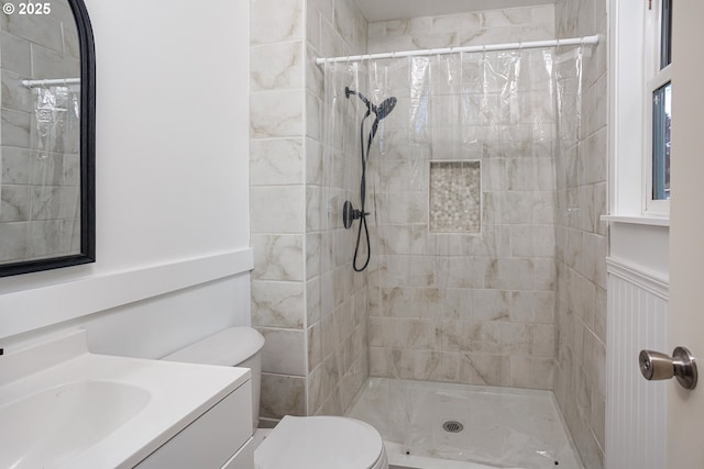 bathroom featuring walk in shower, vanity, and toilet