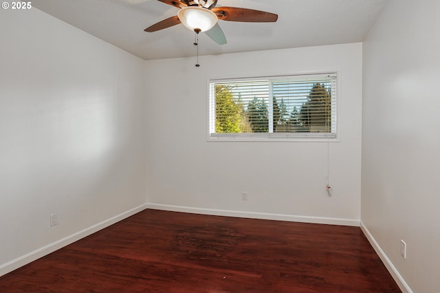 empty room with dark hardwood / wood-style flooring and ceiling fan