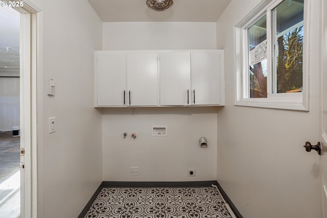 washroom with cabinets, hookup for an electric dryer, and hookup for a washing machine