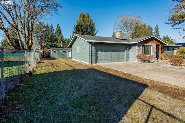 exterior space featuring a garage and a lawn