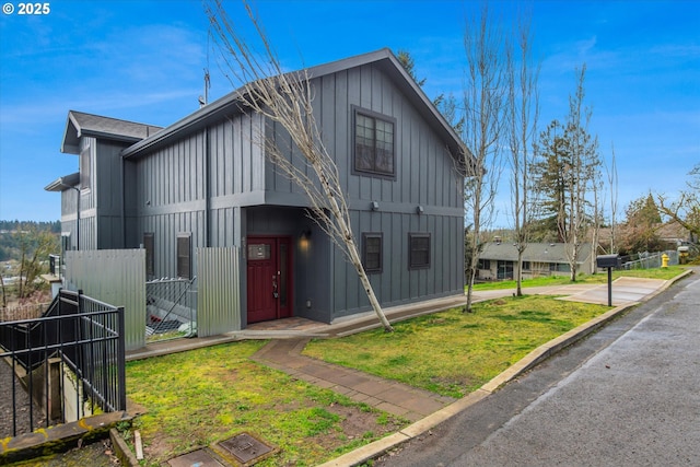 view of front of house featuring a front lawn and board and batten siding