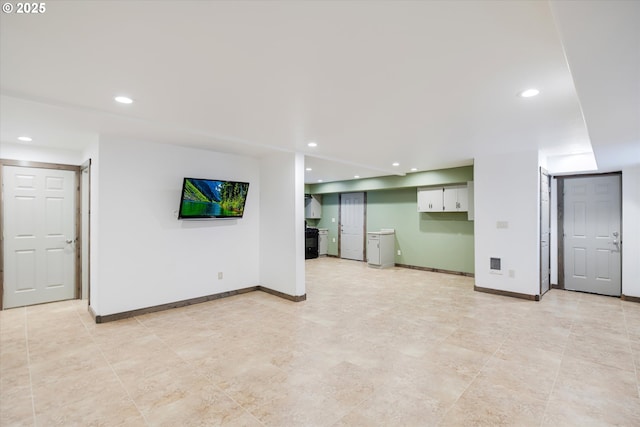 unfurnished living room featuring baseboards and recessed lighting