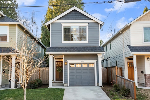 view of property featuring a garage and a front yard