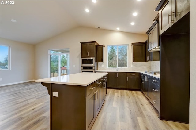 1636 N Millican Crfeek St, Lafayette, OR 97127 - kitchen with light wood finished floors, plenty of natural light, dark brown cabinets, vaulted ceiling, and stainless steel appliances