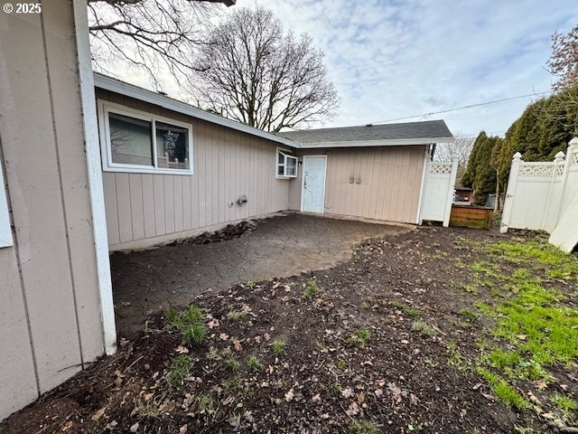 rear view of house with fence