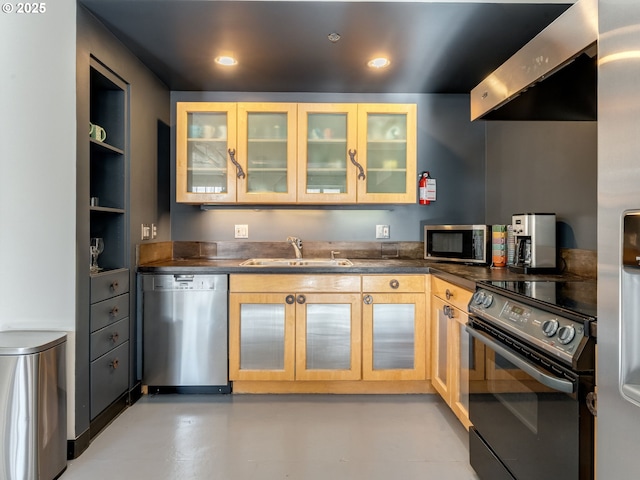 kitchen featuring light brown cabinetry, sink, extractor fan, and appliances with stainless steel finishes