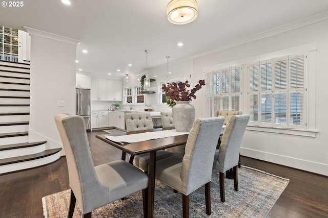 dining room featuring ornamental molding, dark hardwood / wood-style floors, and a healthy amount of sunlight