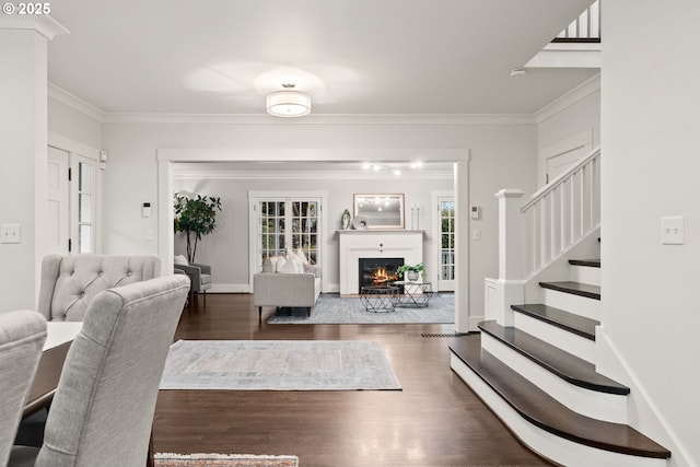 living room featuring ornamental molding and dark wood-type flooring