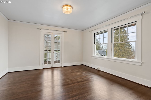 empty room featuring ornamental molding and dark hardwood / wood-style floors