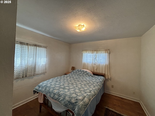 410 Division St, Elgin, OR 97827 - bedroom with baseboards, a textured ceiling, and wood finished floors
