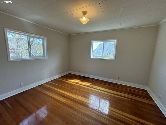 410 Division St, Elgin, OR 97827 - spare room with crown molding, dark wood-style floors, plenty of natural light, and visible vents