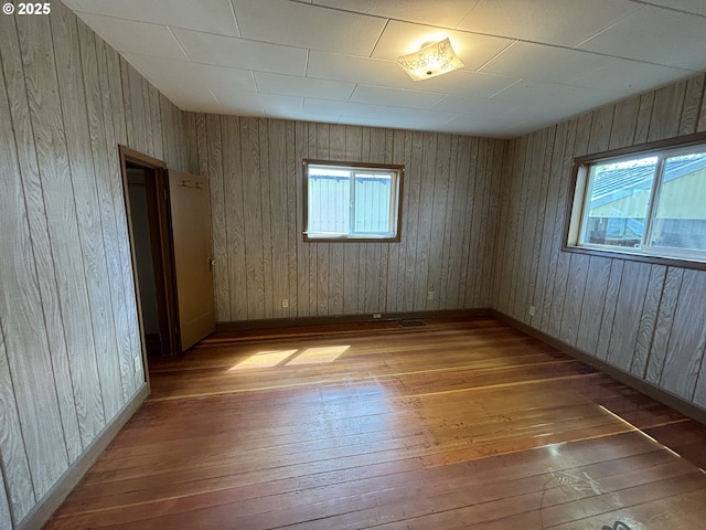 410 Division St, Elgin, OR 97827 - empty room with baseboards, wood walls, and hardwood / wood-style flooring