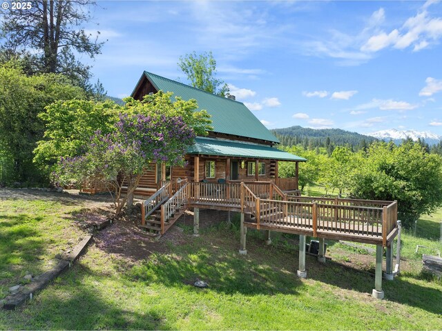 35912 Valley View Ln, Halfway, OR 97834 - back of property with metal roof, log exterior, a lawn, and a deck with mountain view