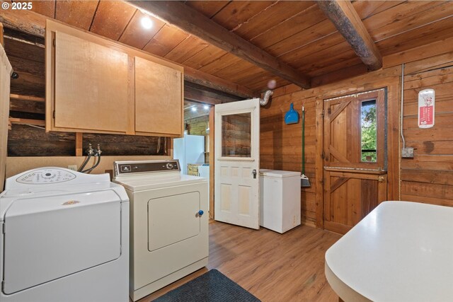 35912 Valley View Ln, Halfway, OR 97834 - laundry area with cabinet space, wooden ceiling, washing machine and clothes dryer, wooden walls, and light wood-style flooring