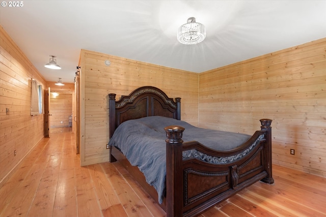 35912 Valley View Ln, Halfway, OR 97834 - bedroom with wooden walls, a chandelier, and hardwood / wood-style flooring