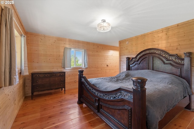 35912 Valley View Ln, Halfway, OR 97834 - bedroom featuring wooden walls, hardwood / wood-style floors, and a chandelier