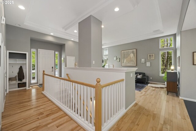hallway featuring baseboards, recessed lighting, light wood-style flooring, and an upstairs landing