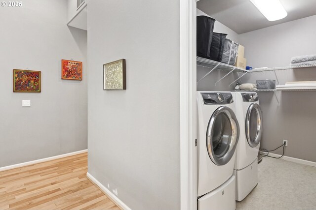 washroom with laundry area, baseboards, independent washer and dryer, and light wood-style floors