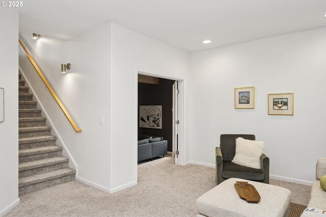 living area with carpet flooring, recessed lighting, baseboards, and stairway