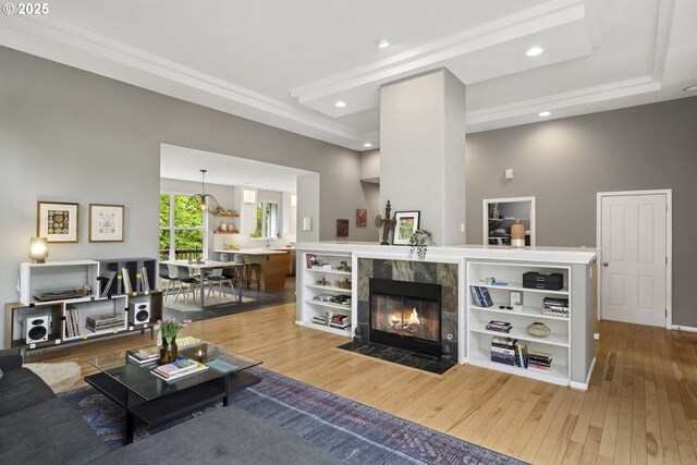 living room featuring recessed lighting, hardwood / wood-style floors, and a tile fireplace