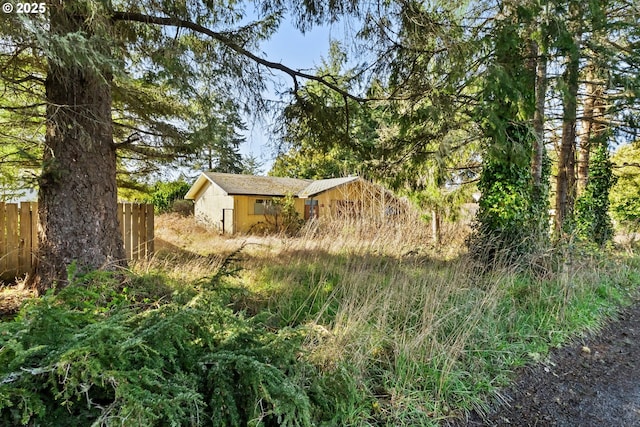 exterior space featuring fence and an outdoor structure