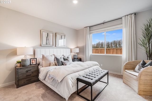 bedroom featuring baseboards and light colored carpet