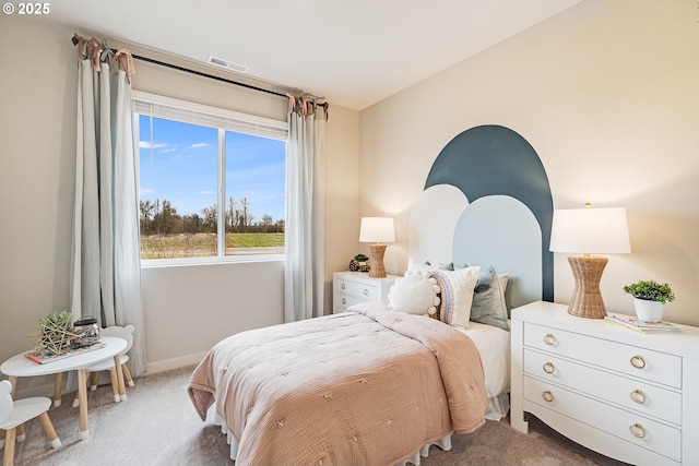 bedroom with carpet floors, visible vents, and baseboards