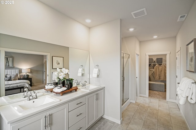 full bathroom with visible vents, a sink, and a shower stall