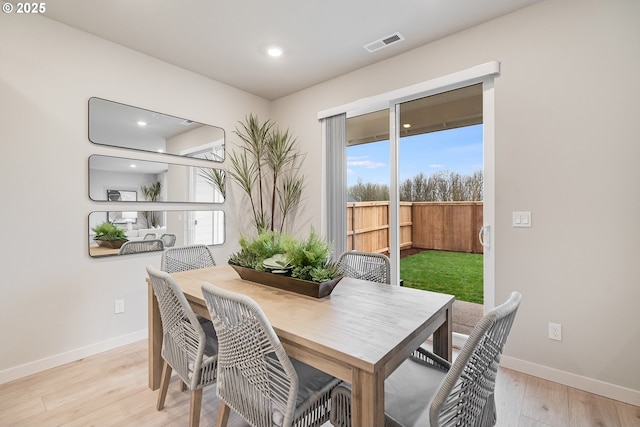 dining room with light wood-type flooring, baseboards, visible vents, and recessed lighting