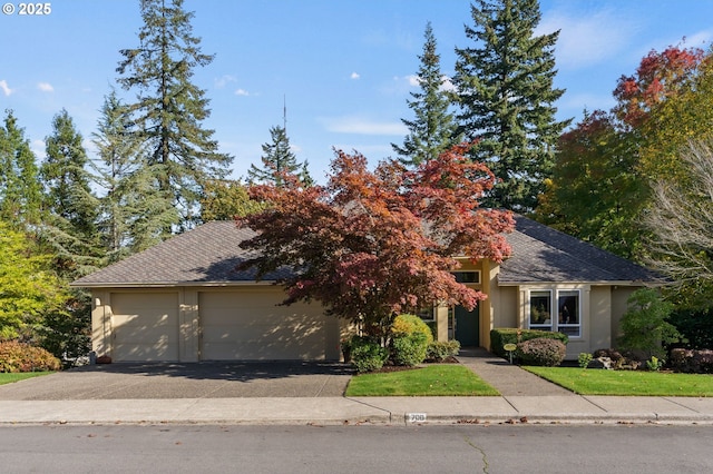 obstructed view of property with stucco siding, an attached garage, roof with shingles, and aphalt driveway