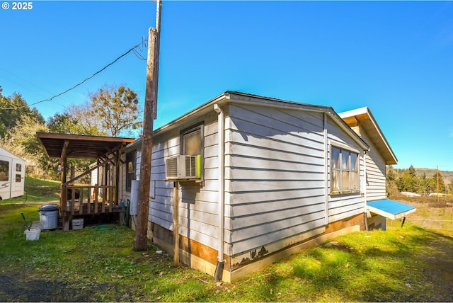 view of side of home with cooling unit and a yard