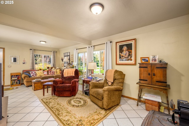 living area featuring light tile patterned floors, plenty of natural light, beamed ceiling, and baseboards