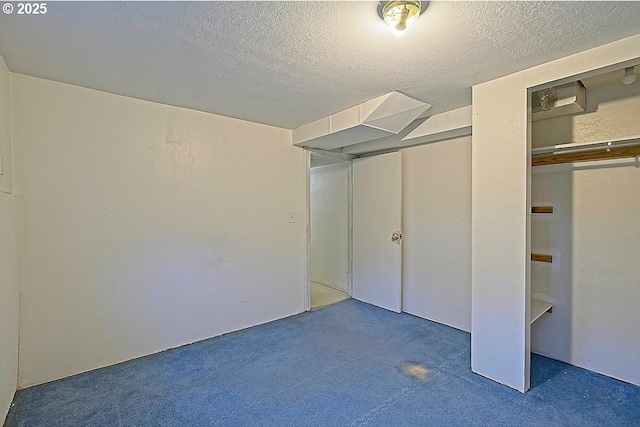 unfurnished bedroom with carpet floors and a textured ceiling