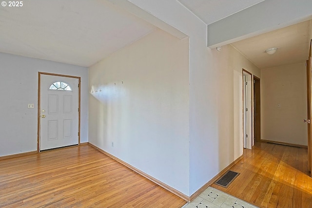 entrance foyer featuring baseboards, visible vents, and light wood-style floors