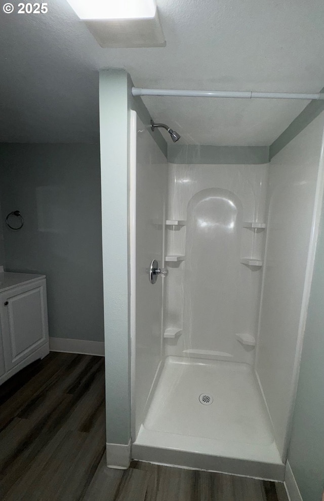 1605 4th St, Salem, OR 97301 - full bath with wood finished floors, baseboards, a shower stall, and vanity