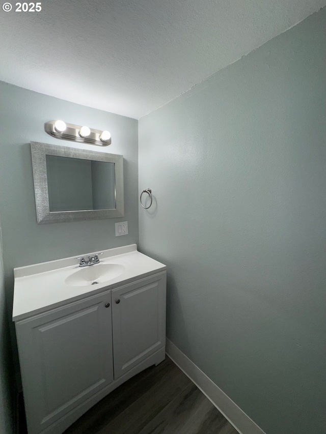 1605 4th St, Salem, OR 97301 - bathroom with wood finished floors, vanity, and baseboards