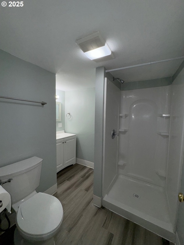1605 4th St, Salem, OR 97301 - bathroom with wood finished floors, vanity, walk in shower, toilet, and baseboards