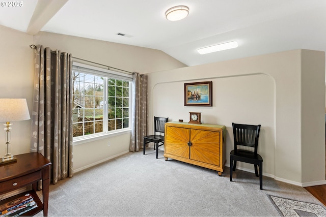 sitting room with visible vents, lofted ceiling, carpet, and baseboards