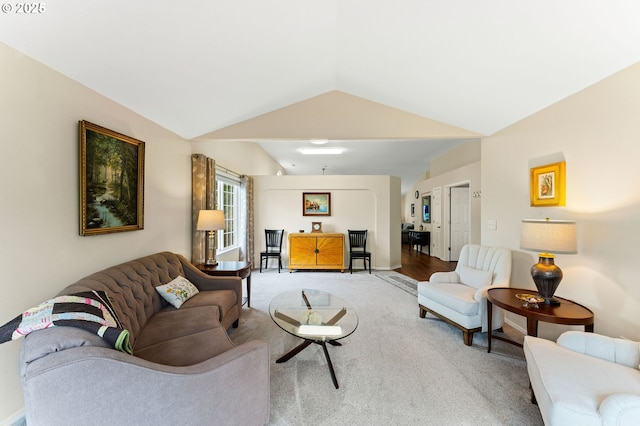 living room featuring vaulted ceiling and light colored carpet