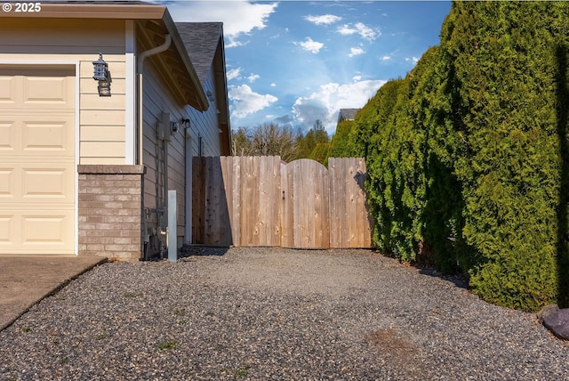 view of yard featuring a garage and fence