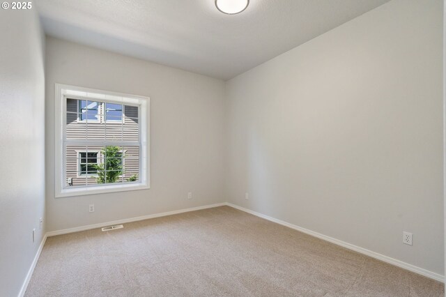 1225 NE 3rd Ave, Hillsboro, OR 97124 - carpeted spare room featuring baseboards
