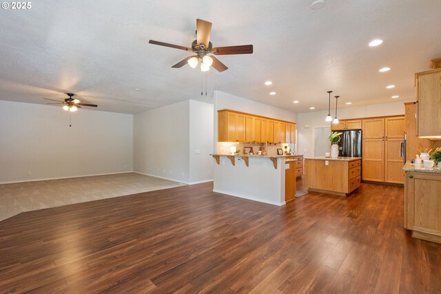 1225 NE 3rd Ave, Hillsboro, OR 97124 - kitchen featuring ceiling fan, freestanding refrigerator, recessed lighting, dark wood-type flooring, and a breakfast bar area