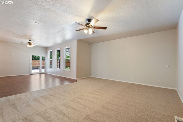 1225 NE 3rd Ave, Hillsboro, OR 97124 - unfurnished living room with ceiling fan, carpet floors, and a textured ceiling