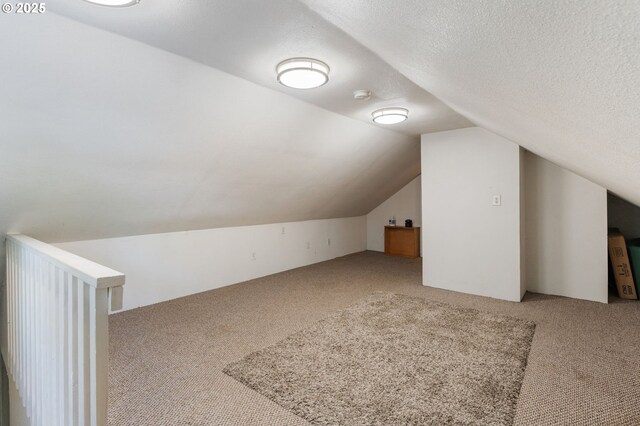 1225 NE 3rd Ave, Hillsboro, OR 97124 - additional living space with carpet flooring, vaulted ceiling, and a textured ceiling