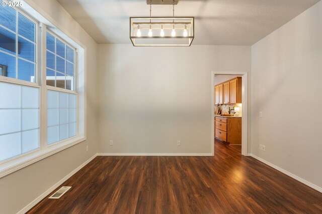 1225 NE 3rd Ave, Hillsboro, OR 97124 - unfurnished dining area with dark wood finished floors and baseboards