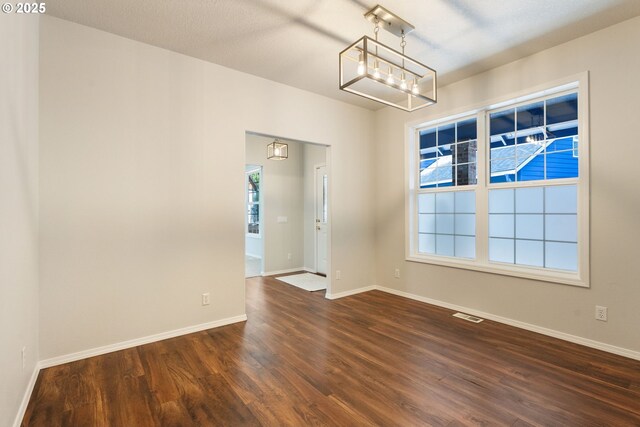 1225 NE 3rd Ave, Hillsboro, OR 97124 - spare room with dark wood-type flooring and a chandelier