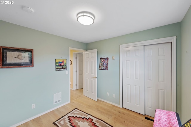 bedroom featuring light hardwood / wood-style floors and a closet